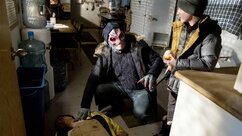 Alien Harry checks a dead man's pulse and looks up at Max Hawthorne in Resident Alien Episode 303.