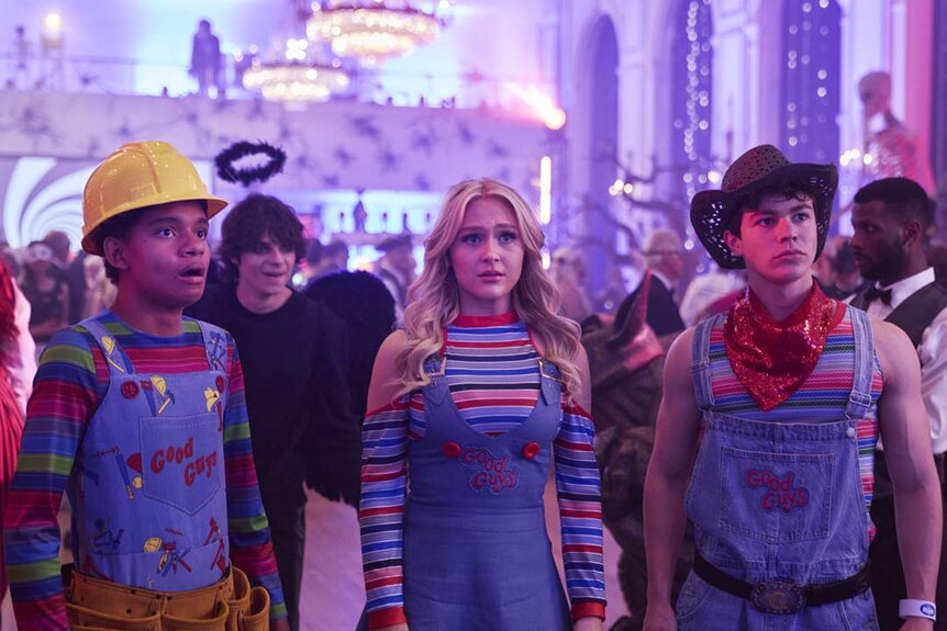 (l-r) Devon Evans (Björgvin Arnarson), Grant Collins (Jackson Kelly), Lexy Cross (Alyvia Alyn Lind), and Jake Wheeler (Zackary Arthur) stand together in Halloween costumes at a party.